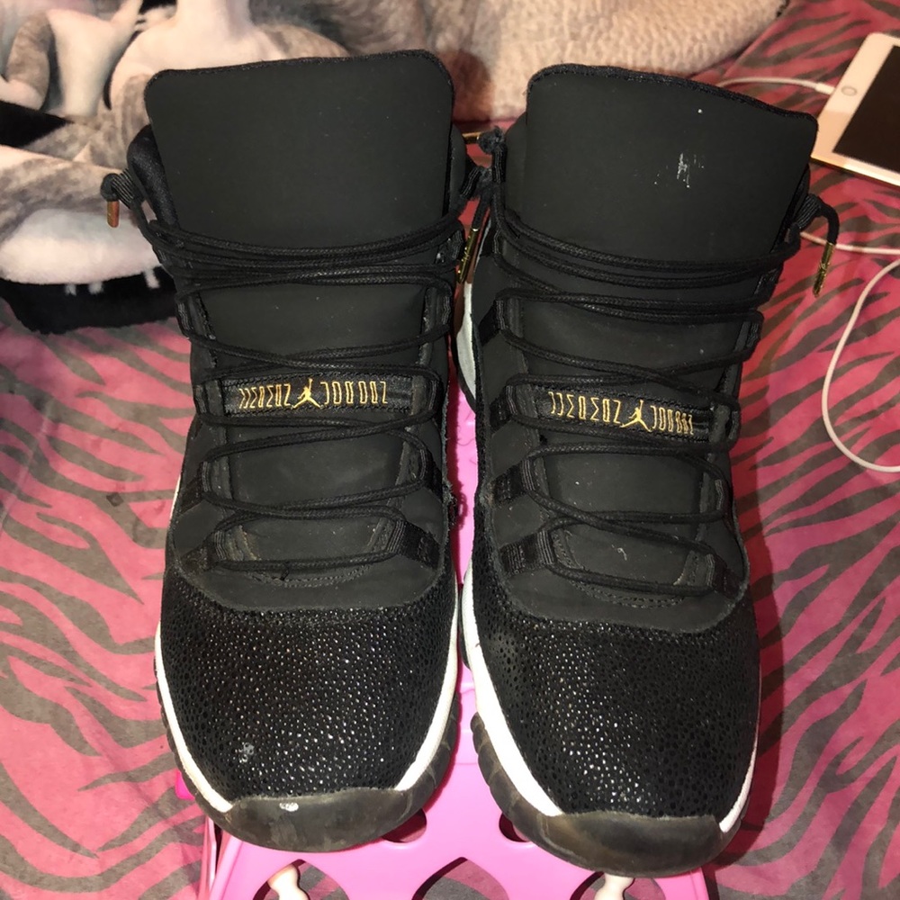 Jordan 11’s, black and gold jump-man